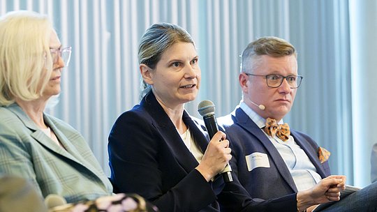 Podiumsteilnehmerin während ihres Wortbeitrags mit Handmikrofon